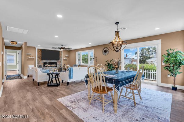 Chandelier, Dining room, Fireplace, Interior, Living room, Pendant Lights, Recessed Lighting, Wood Texture Flooring