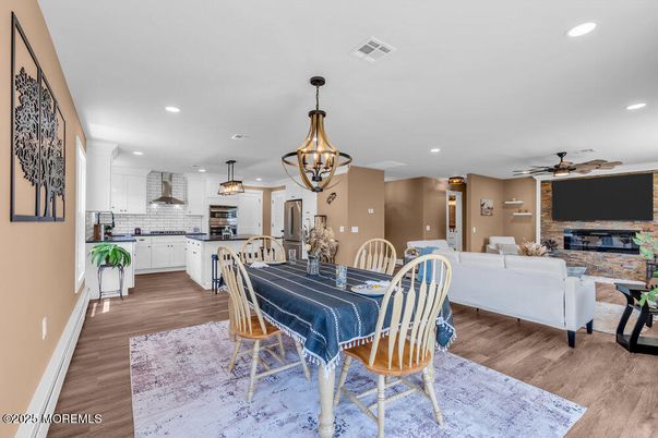 Dining room, Fireplace, Interior, Kitchen, Living room, Pendant Lights, Recessed Lighting, Stainless Steel Appliances, Stone Walls, Wood Texture Flooring