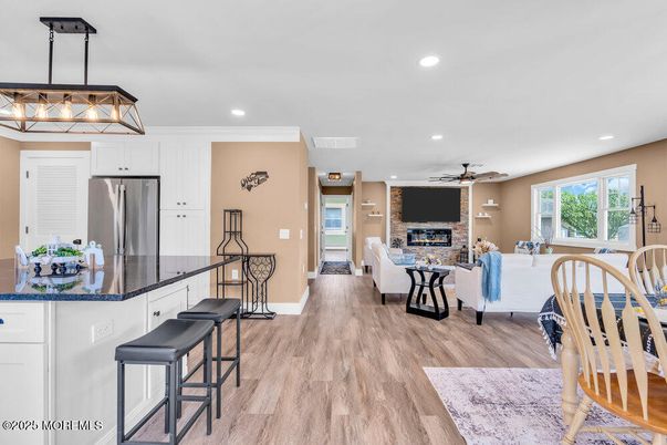 Fireplace, Interior, Kitchen, Living room, Pendant Lights, Recessed Lighting, Stainless Steel Appliances, Wood Texture Flooring