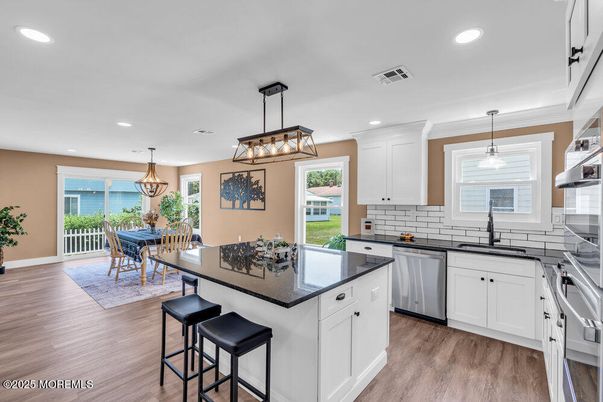 Chandelier, Dining room, Interior, Kitchen, Pendant Lights, Recessed Lighting, Water, Wood Texture Flooring