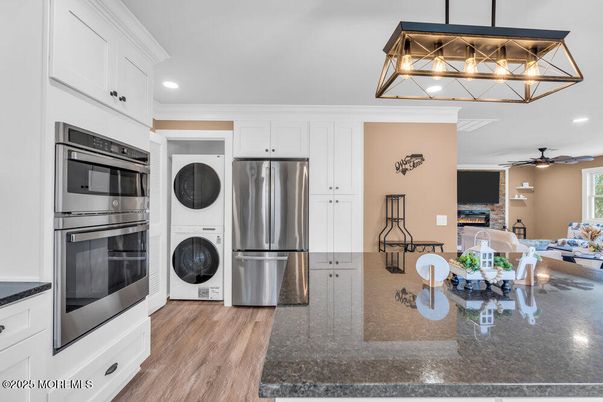 Dining room, Fireplace, Interior, Kitchen, Recessed Lighting, Stainless Steel Appliances, Wood Texture Flooring
