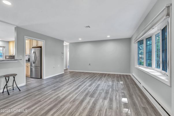 Empty room, Interior, Kitchen, Recessed Lighting, Stainless Steel Appliances, Wood Texture Flooring