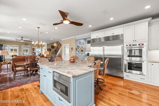 Chandelier, Dining room, Interior, Kitchen, Recessed Lighting, Stainless Steel Appliances, Wood Texture Flooring