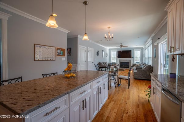 Chandelier, Dining room, Fireplace, Interior, Kitchen, Living room, Pendant Lights, Wood Texture Flooring