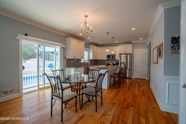 Chandelier, Dining room, Interior, Kitchen, Pendant Lights, Recessed Lighting, Stainless Steel Appliances, Wood Texture Flooring