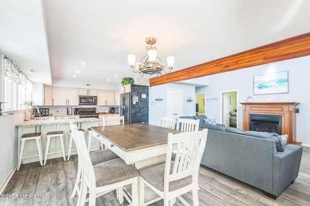 Chandelier, Dining room, Fireplace, Interior, Kitchen, Living room, Recessed Lighting, Wood Texture Flooring