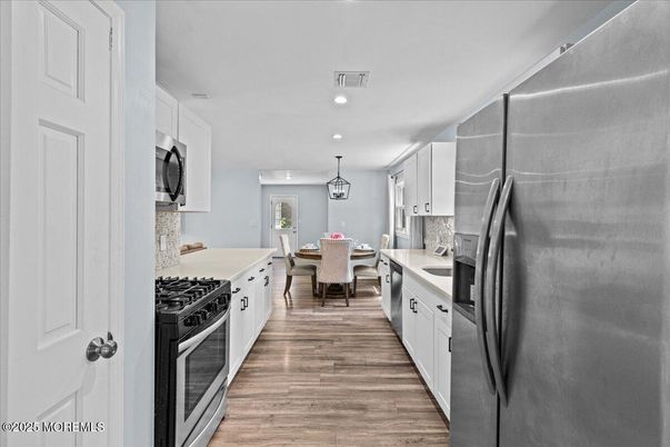 Dining room, Interior, Kitchen, Pendant Lights, Recessed Lighting, Stainless Steel Appliances, Wood Texture Flooring