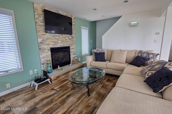 Fireplace, Interior, Living room, Recessed Lighting, Stone Walls, Wood Texture Flooring