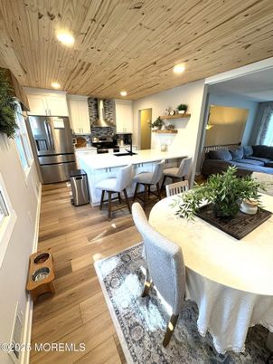 Dining room, Interior, Kitchen, Living room, Recessed Lighting, Stainless Steel Appliances, Wooden Ceilings, Wood Texture Flooring