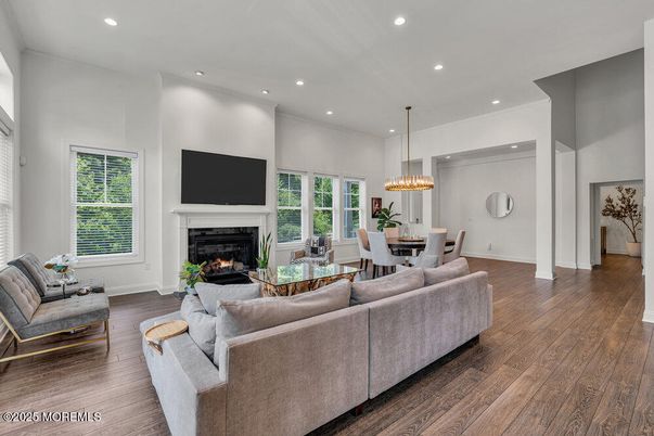Chandelier, Dining room, Fireplace, Interior, Living room, Pendant Lights, Recessed Lighting, Wood Texture Flooring