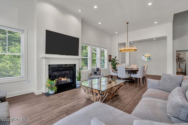 Chandelier, Dining room, Fireplace, Interior, Living room, Pendant Lights, Recessed Lighting, Wood Texture Flooring