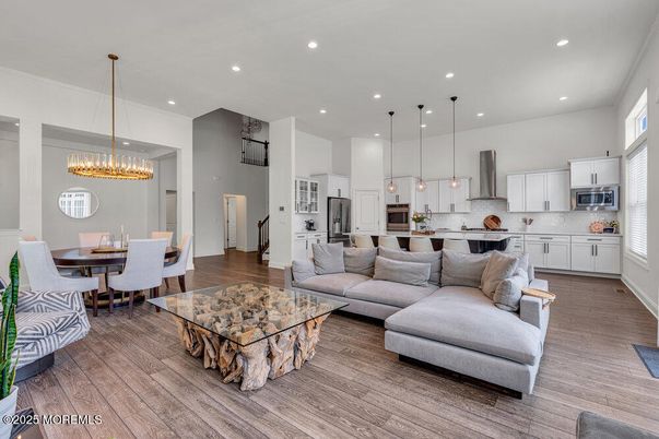 Chandelier, Dining room, Interior, Kitchen, Living room, Pendant Lights, Recessed Lighting, Stainless Steel Appliances, Wood Texture Flooring
