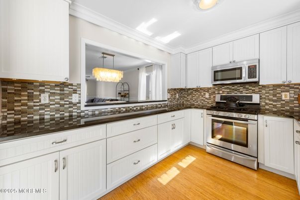 Chandelier, Interior, Kitchen, Pendant Lights, Recessed Lighting, Stainless Steel Appliances, Wood Texture Flooring