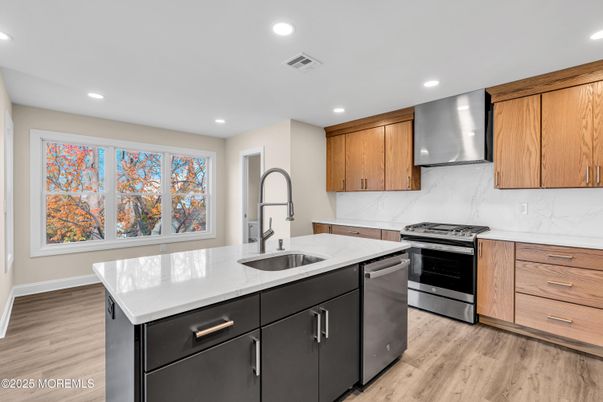 Interior, Kitchen, Marble Walls, Recessed Lighting, Stainless Steel Appliances, Wood Texture Flooring