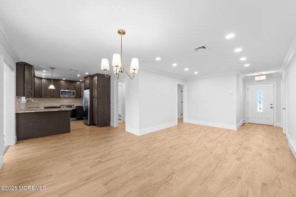 Chandelier, Empty room, Interior, Kitchen, Pendant Lights, Recessed Lighting, Stainless Steel Appliances, Wood Texture Flooring