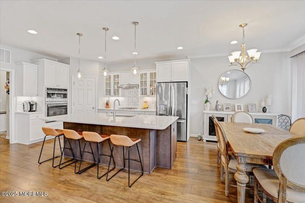 Chandelier, Dining room, Interior, Kitchen, Pendant Lights, Recessed Lighting, Stainless Steel Appliances, Wood Texture Flooring