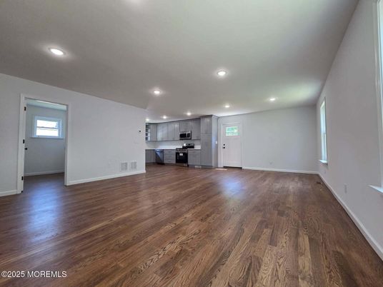 Empty room, Interior, Kitchen, Recessed Lighting, Stainless Steel Appliances, Wood Texture Flooring