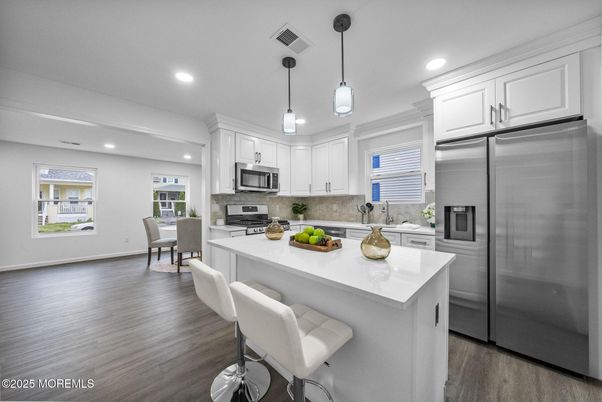 Dining room, Interior, Kitchen, Pendant Lights, Recessed Lighting, Stainless Steel Appliances, Wood Texture Flooring