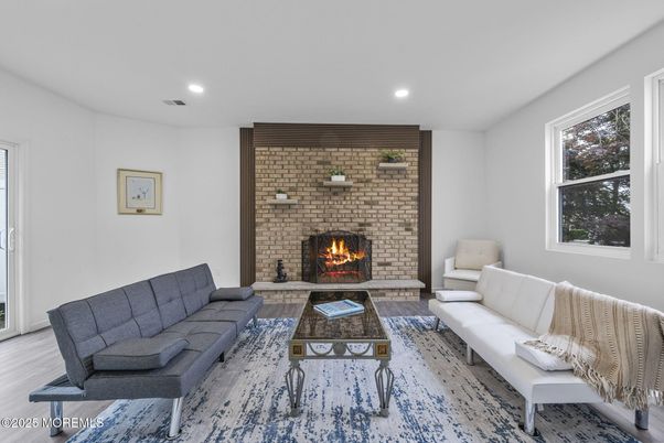 Fireplace, Interior, Living room, Recessed Lighting, Stone Walls, Wood Texture Flooring