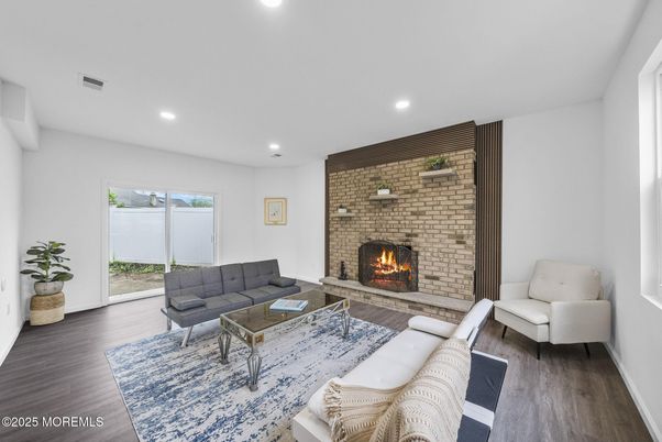 Fireplace, Interior, Living room, Recessed Lighting, Stone Walls, Wood Texture Flooring