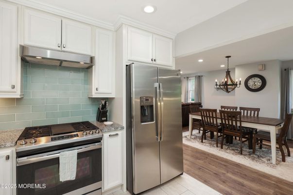 Chandelier, Dining room, Interior, Kitchen, Recessed Lighting, Stainless Steel Appliances, Wood Texture Flooring