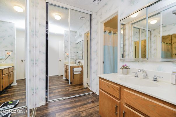Bathroom, Dual Sink Vanities, Glass Shower, Interior, Marble Walls, Wood Texture Flooring