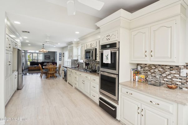 Chandelier, Dining room, Interior, Kitchen, Pendant Lights, Recessed Lighting, Stainless Steel Appliances, Wood Texture Flooring