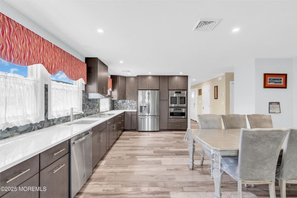 Dining room, Interior, Kitchen, Recessed Lighting, Stainless Steel Appliances, Wood Texture Flooring