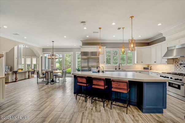 Chandelier, Dining room, Interior, Kitchen, Pendant Lights, Recessed Lighting, Stainless Steel Appliances, Wood Texture Flooring