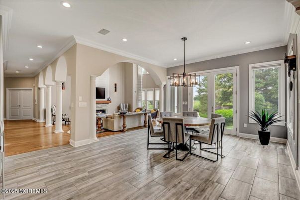 Chandelier, Dining room, Fireplace, Interior, Living room, Pendant Lights, Recessed Lighting, Wood Texture Flooring