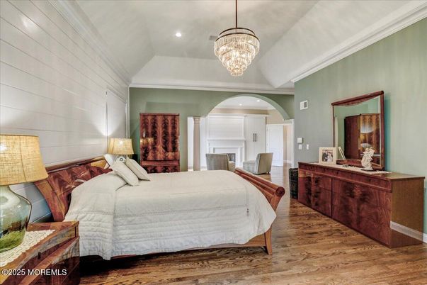 Bedroom, Chandelier, Fireplace, Interior, Recessed Lighting, Wood Texture Flooring