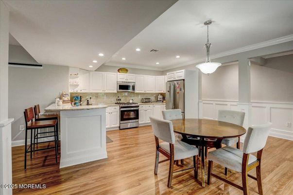 Dining room, Interior, Kitchen, Pendant Lights, Recessed Lighting, Stainless Steel Appliances, Wood Texture Flooring