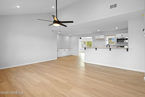 Empty room, Interior, Kitchen, Recessed Lighting, Stainless Steel Appliances, Wood Texture Flooring
