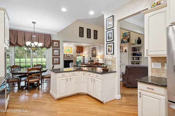 Chandelier, Dining room, Fireplace, Interior, Kitchen, Recessed Lighting, Wood Texture Flooring