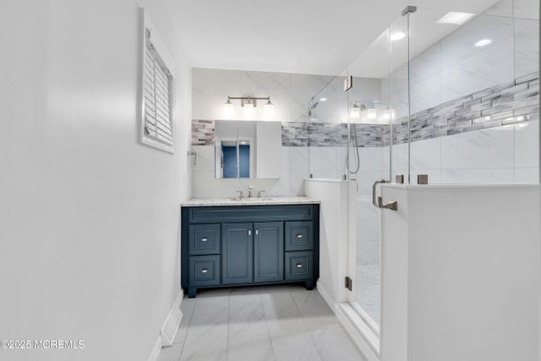 Bathroom, Dual Sink Vanities, Glass Shower, Interior, Marble, Marble Walls, Recessed Lighting