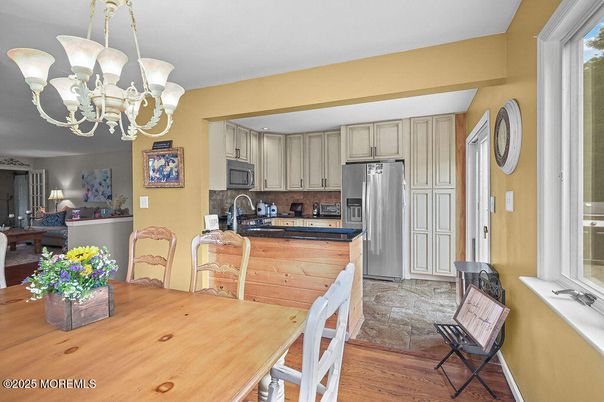 Chandelier, Dining room, Interior, Kitchen, Stainless Steel Appliances, Wood Texture Flooring