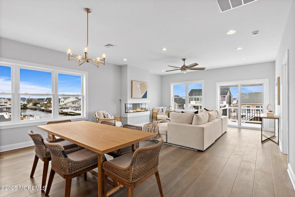 Dining room, Fireplace, Interior, Living room, Pendant Lights, Recessed Lighting, Water, Wood Texture Flooring