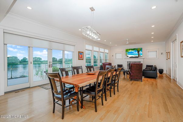Dining room, Fireplace, Interior, Living room, Pendant Lights, Recessed Lighting, Water, Wood Texture Flooring