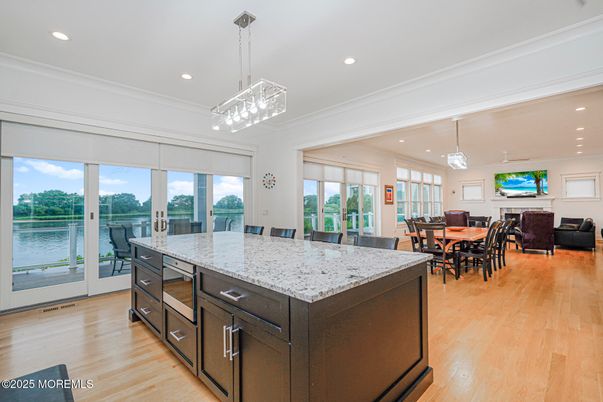 Dining room, Fireplace, Interior, Kitchen, Living room, Pendant Lights, Recessed Lighting, Water, Wood Texture Flooring