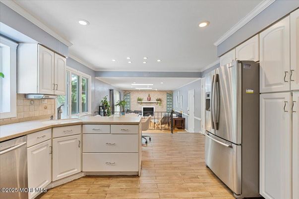 Fireplace, Interior, Kitchen, Recessed Lighting, Stainless Steel Appliances, Stone Walls, Wood Texture Flooring