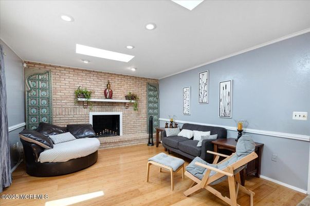 Fireplace, Interior, Living room, Recessed Lighting, Stone Walls, Wood Texture Flooring