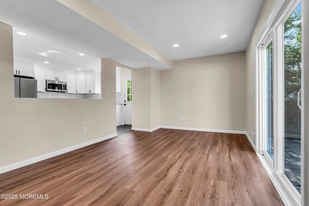 Empty room, Interior, Kitchen, Recessed Lighting, Stainless Steel Appliances, Wood Texture Flooring