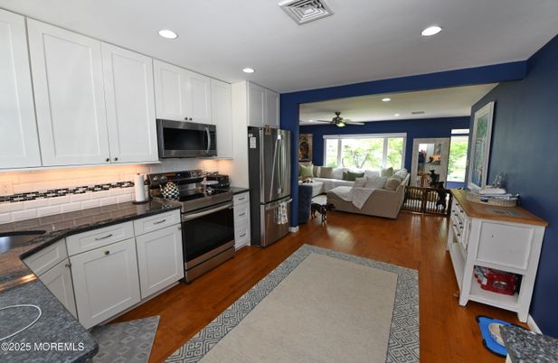 Dining room, Interior, Kitchen, Living room, Recessed Lighting, Stainless Steel Appliances, Wood Texture Flooring