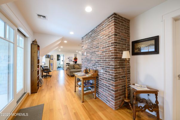 Fireplace, Interior, Living room, Recessed Lighting, Stone Walls, Wood Texture Flooring