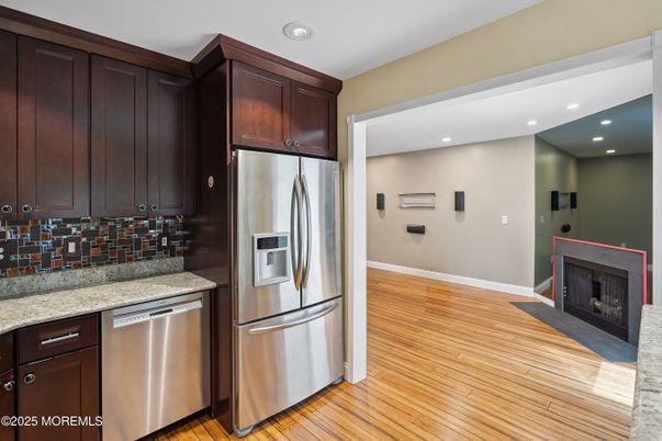 Fireplace, Interior, Kitchen, Recessed Lighting, Stainless Steel Appliances, Wood Texture Flooring