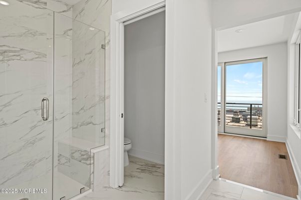 Bathroom, Glass Shower, Interior, Marble, Marble Walls, Recessed Lighting, Water, Wood Texture Flooring