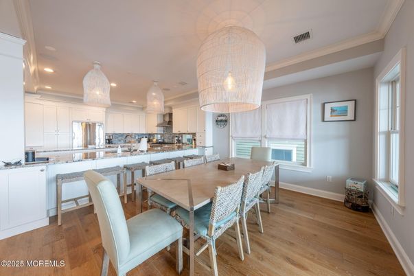 Chandelier, Dining room, Interior, Kitchen, Pendant Lights, Recessed Lighting, Stainless Steel Appliances, Wood Texture Flooring