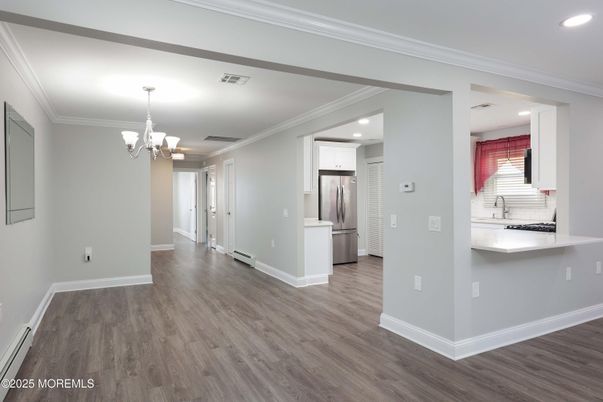 Chandelier, Empty room, Interior, Kitchen, Recessed Lighting, Stainless Steel Appliances, Wood Texture Flooring
