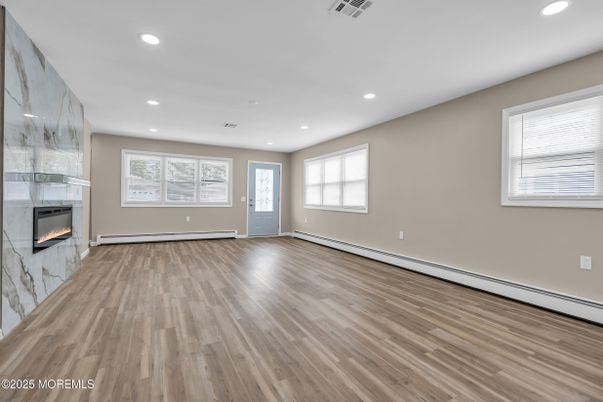 Empty room, Fireplace, Interior, Marble Walls, Recessed Lighting, Wood Texture Flooring