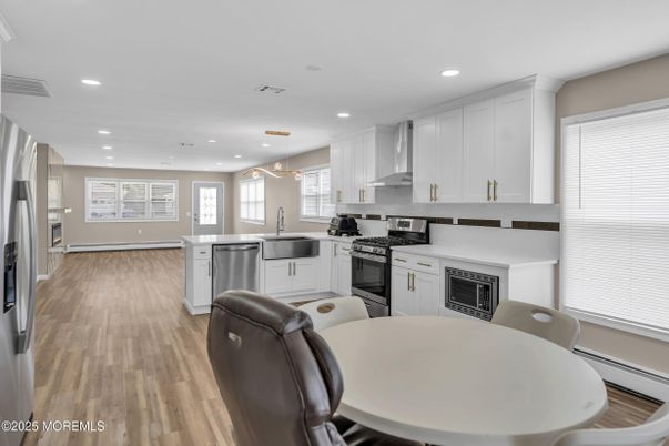 Dining room, Interior, Kitchen, Pendant Lights, Recessed Lighting, Stainless Steel Appliances, Wood Texture Flooring